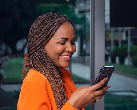 A business owner smiling at her phone